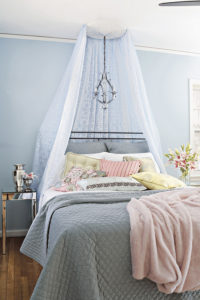 Girl bedroom with pink accents and a canopy