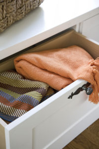 drawers under the window seat, where blankets, throws and pillows are kept