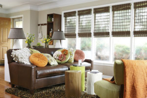 Living room with leather sofa and big windows
