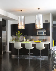 modern kitchen with dark cabinetry and horizontal cabinet pulls